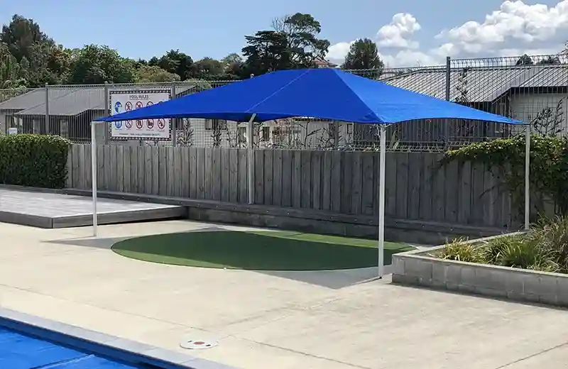 Education-gallery-Image-5 Blue shade sail structure providing UV protection beside a school swimming pool in New Zealand
