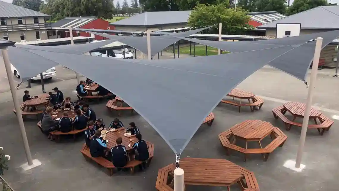 Shade-sails-for-Napier-Boys-Hostel Large customised shade sail canopy covering outdoor seating area at Napier Boys Hostel