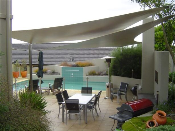 Sunshade NZ waterproof DriZ shade sail installed over a residential outdoor area for year-round weather protection